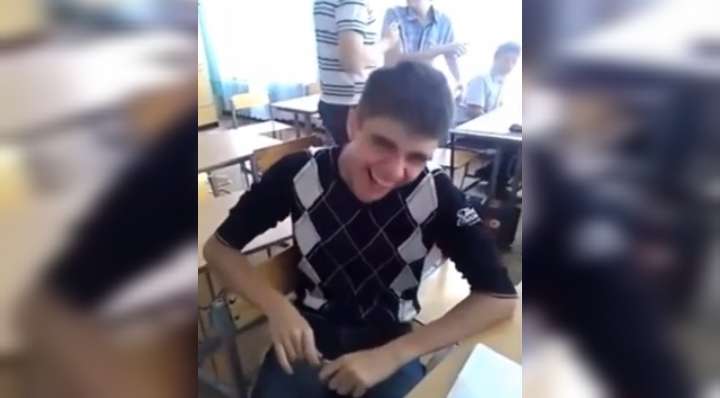 Boy laughing like dog in classroom video meme